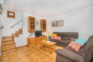a living room with a couch and a table at Sontuiri den Jaume in Pollença