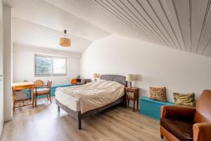 a bedroom with a bed and a table and chairs at Cap sur la détente - 128 in Pornic