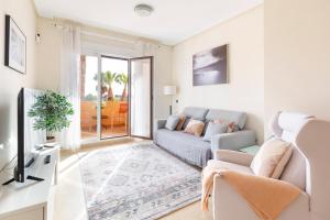 a living room with a couch and a tv at Golf And Sun in Los Alcázares