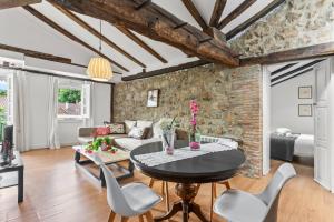 a living room with a table and chairs at Apartamento 3 Casa Las Indianas in Selores +14 photos