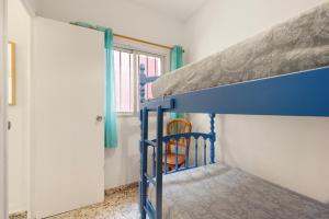 a blue bunk bed in a room with a window at Casa Coral Beach in Málaga