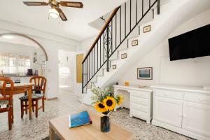 a living room with a table and a tv at Casa Coral Beach in Málaga