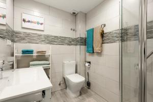 a bathroom with a toilet and a shower at Casa Coral Beach in Málaga +12 photos