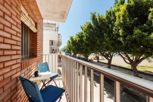 two chairs sitting on a balcony next to a building at Casa Coral Beach in Málaga