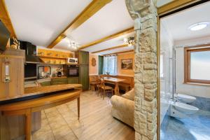 a kitchen and living room with a dining room at Appartamento Padola 72 in Padola