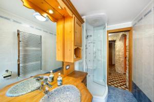 a bathroom with a sink and a shower at Appartamento Padola 72 in Padola