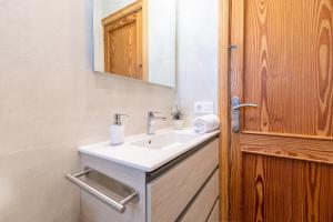 a bathroom with a sink and a mirror at Apartamento Minerva in Alcudia +19 photos