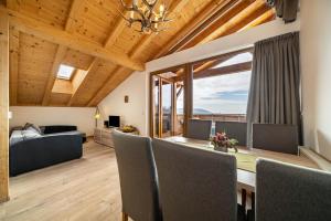 a dining room with a table and chairs and a bedroom at Eggerhof Fernblick in Verano