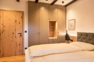 a bedroom with two beds and a closet at Residence Skutial App Schlern in Castelrotto