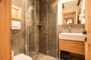 a bathroom with a shower and a sink at Residence Skutial App Schlern in Castelrotto +19 photos