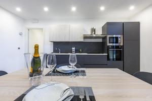 a kitchen with a table with wine glasses on it at Casa Gioiosa Holidays in Gioiosa Marea