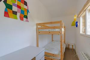 a room with a bunk bed and a ladder at Gite Bellevue in Paulin