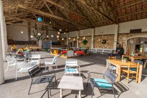 a group of chairs and tables in a large room at Gite Bellevue in Paulin