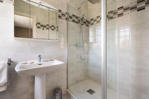 a white bathroom with a sink and a shower at La Mansardière in Cancale +39 photos