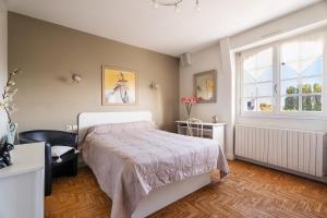 a bedroom with a bed and a window at La Mansardière in Cancale