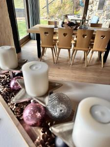 a kitchen sink with candles and a table and chairs at Bergchalet h e i m a t in San Martino +35 photos