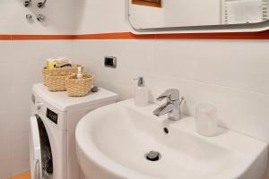 a bathroom with a sink and a washing machine at La Casetta Chiesa Valmalenco in Chiesa in Valmalenco +16 photos