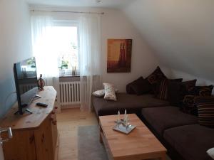a living room with a couch and a table at Haus Maruna in Schauenburg
