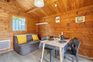 a dining room with a table and a couch at Chalet confort 20 in Saint-Gervais +19 photos