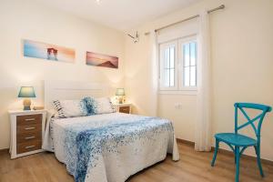 a bedroom with a bed and a chair and a window at Casa Orilla Sur B in El Palmar +19 photos