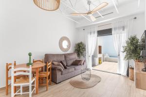 a living room with a couch and a table at Casa Catral Alfalfar 12 in Catral