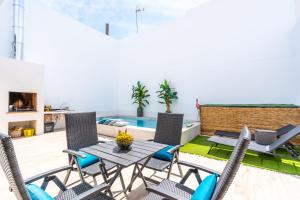 a patio with a table and chairs and a pool at Casa Catral Alfalfar 12 in Catral