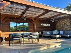 a patio with a table and chairs next to a pool at La Petite Maison Jaune in Grimaud