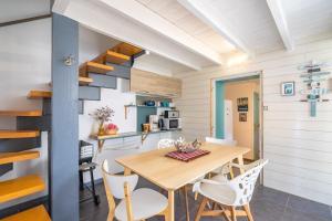 a kitchen and dining room with a wooden table and chairs at Gite Du Porche Bis in Chaillevette