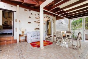 a living room with a dining table and chairs at Casa de Campo in Betancuría +17 photos