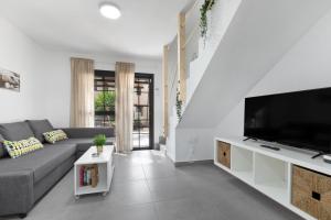 a living room with a couch and a flat screen tv at Casa Curro Costa Calma in Costa Calma