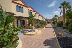 a brick walkway in front of a house with palm trees at Casa Curro Costa Calma in Costa Calma