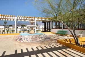 a table with a fountain in a courtyard with a bench at Estudio Sagrario in Arona