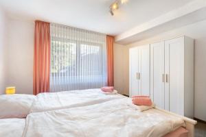 a bedroom with a large bed and a large window at Ferienwohnung Tannenberg in Diemelstadt 