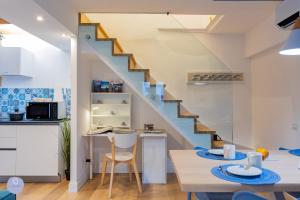 a kitchen and dining room with a staircase at Nido Blu - Vista Lago in Belgirate