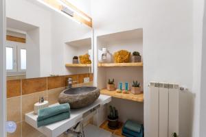 a bathroom with a sink and a mirror at Nido Blu - Vista Lago in Belgirate +33 photos