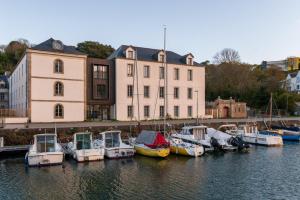 a group of boats docked in the water near a building at Regard Marin - Appartement 4 pers in Le Palais