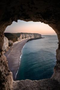 a view of the ocean from a cave at Petit Gîte Douillet L'abri Côtier in Saint-Léonard +12 photos