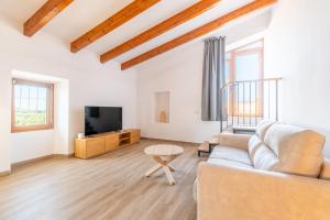 a living room with a couch and a tv at Son Guillem in Son Sardina