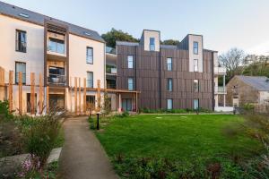 an external view of a building with a grass yard at Regard Marin - Appartement 4 pers in Le Palais +14 photos