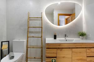 a bathroom with a white sink and a mirror at Ti Clara View Apartment in Caniço +12 photos