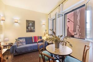 a living room with a table and a couch at Case Sole e Luna in Genoa