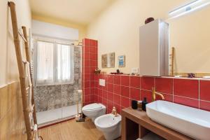 a bathroom with a toilet and a sink and a shower at Case Sole e Luna in Genoa +42 photos
