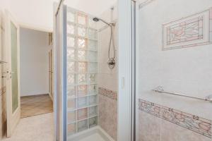 a bathroom with a shower with a glass door at Ardesia Vacanze in Valderice