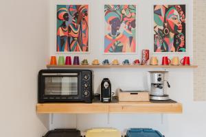 a microwave sitting on a wooden shelf in a kitchen at Ardesia Vacanze in Valderice
