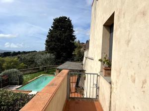 a swimming pool on the balcony of a building at Casa Conte Martini in Palaia