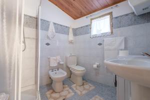 a bathroom with a toilet and a sink at Holiday Home Tommaso e Martina in Savoca +14 photos