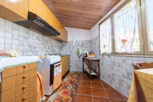 a kitchen with a sink and a dishwasher at Holiday Home Tommaso e Martina in Savoca