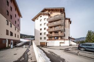a building with balconies on the side of it at Appart 6 pers – Accès direct Ski in Morillon