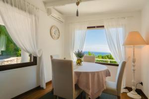 a dining room with a table and a window at Villetta Antonia in Marina di Andora