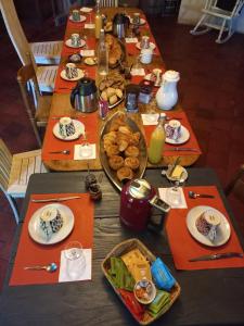 a long table with plates of food on it at Guidon Fourchette et table d'hôtes in Saint-Bonnet-de-Salers